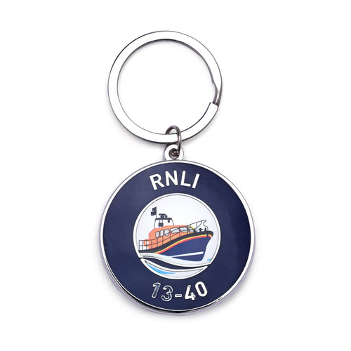 A metal keyring with a round navy charm and an illustration of an RNLI lifeboat.