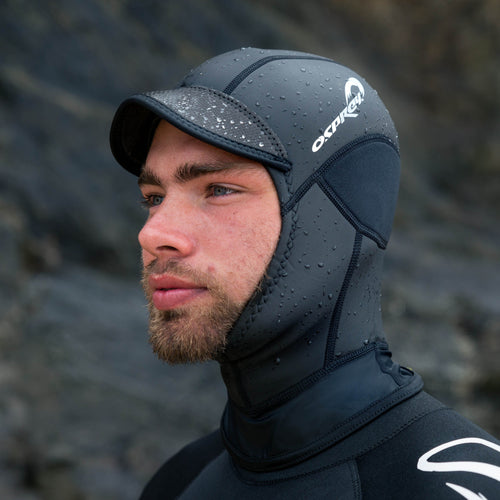 A man wearing a wetsuit and a black Osprey Neoprene Hood.