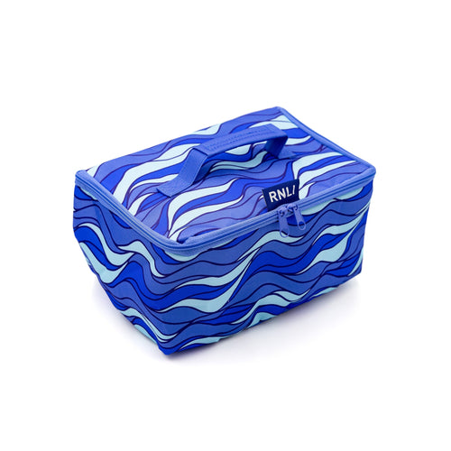 An RNLI Lunch Bag with an all-over blue and white wave print, and a carry handle on the lid.