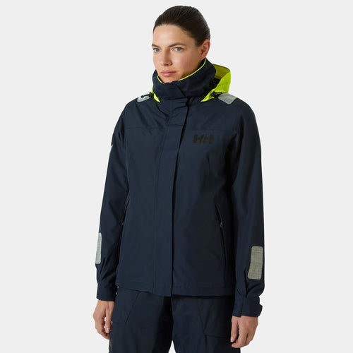 A woman wearing a navy Helly Hansen jacket.