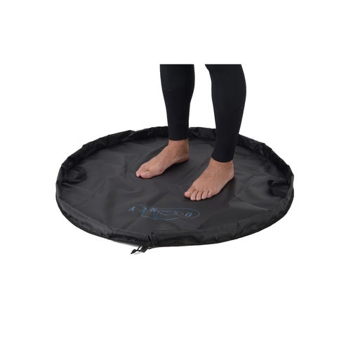 Black, circular watersports changing mat featuring the Osprey logo in blue and a black drawstring.