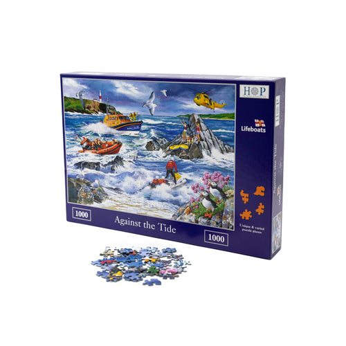 RNLI Against The Tide Jigsaw Puzzle, 1000 pieces. The puzzle image features a stormy coastal scene with lifeguards on a jet ski, two lifeboats and a coastguard helicopter racing to attend a family stranded on rocks.