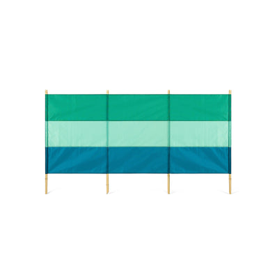 A green and blue striped windbreak with four bamboo poles.