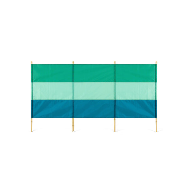 A green and blue striped windbreak with four bamboo poles.