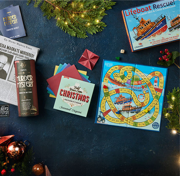  Board game and books on a dark surface with Christmas decorations 