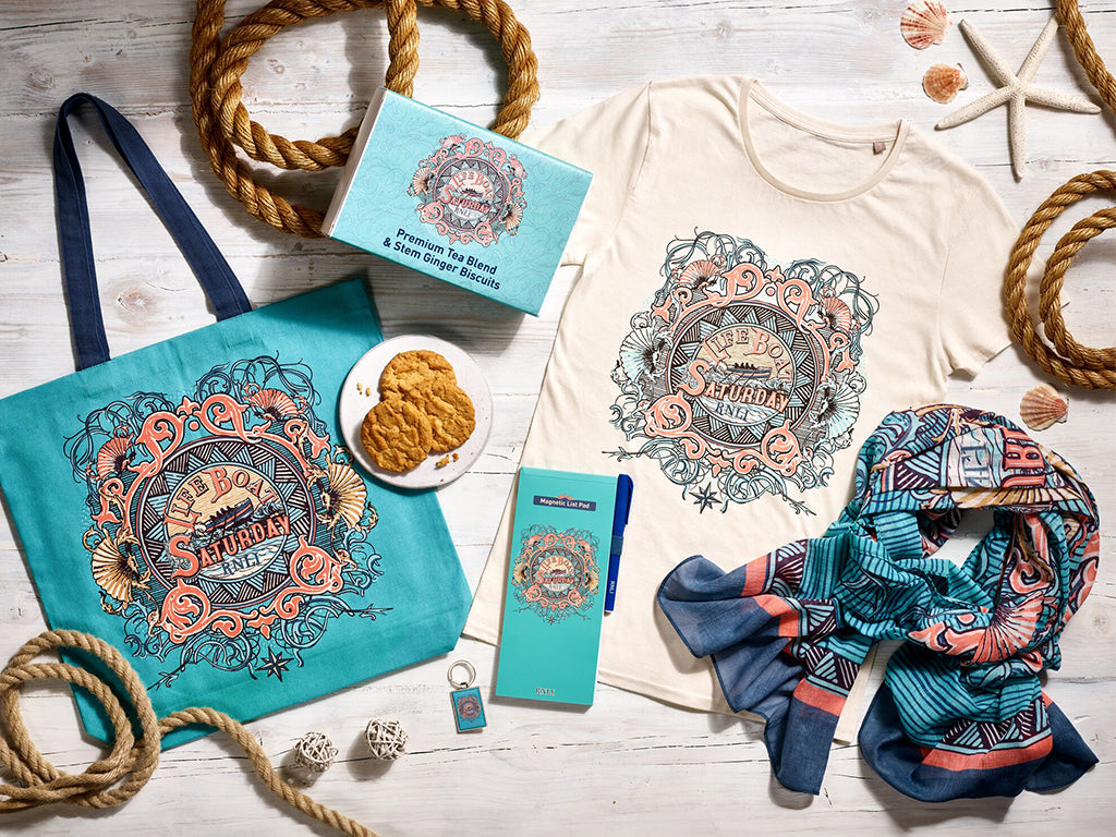 A collection of RNLI Lifeboat Saturday products laid out on a wooden background