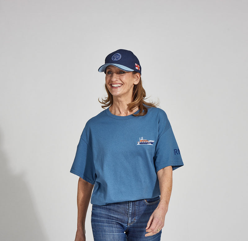  Model wearing RNLIs embroidered boat T-shirt and a 'Royal Oars and Anchor Cap 