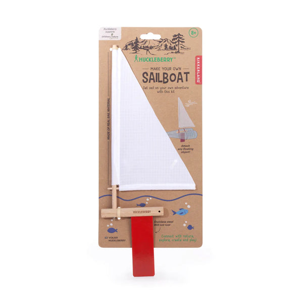 A make you own sail boat kit with a white sail and red rudder.