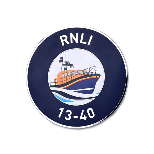 A round, metal magnet with an RNLI Shannon class lifeboat design. 