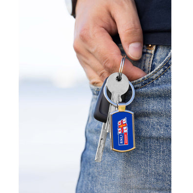 A man holding a set of keys with the RNLI Membership Keyring in the front.
