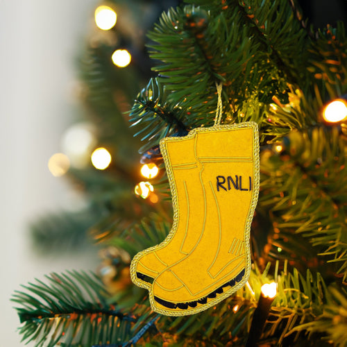 A hanging Christmas decoration in the shape of a pair of RNLI yellow wellies.