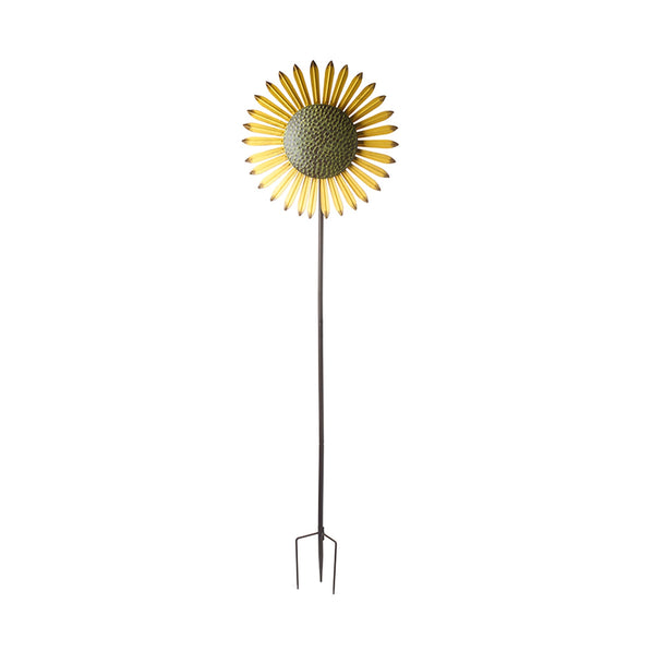 A sunflower windmill on a tall garden stake.