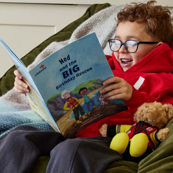 The Big Birthday Rescue Personalised RNLI Book held by a child 