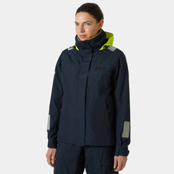 A woman wearing a navy Helly Hansen jacket.