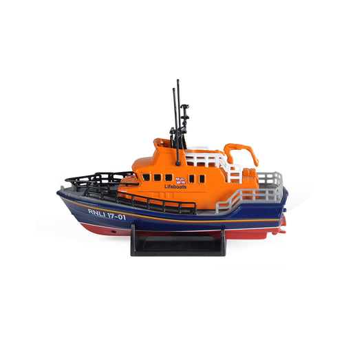 A small, detailed model of the RNLI's Severn class lifeboat. The hull is navy and the cabin is orange. It features details including aerials, a crane and the boat number in white letters. 