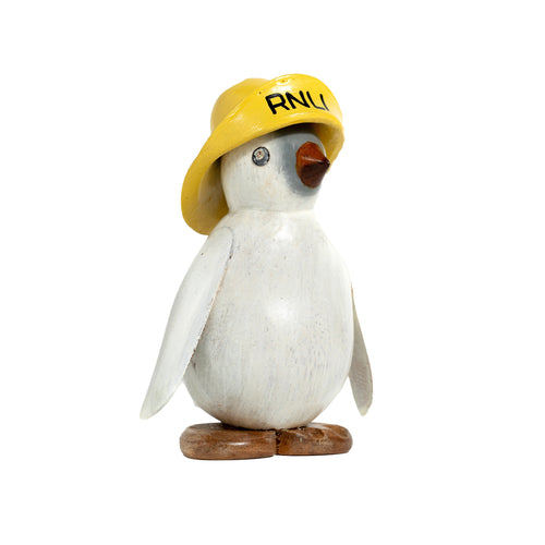 A carved penguin painted all white with a natural wood nose and feet. It has painted black eyes and a yellow hat with 'RNLI' written on it in black.
