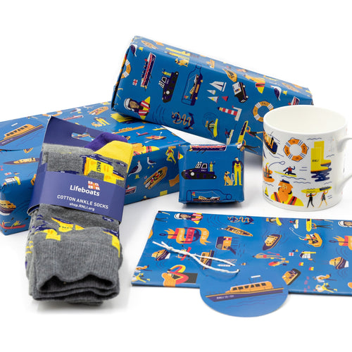 A collection of presents wrapped in RNLI gift wrap that features illustrations of RNLI characters, boats and flags. 