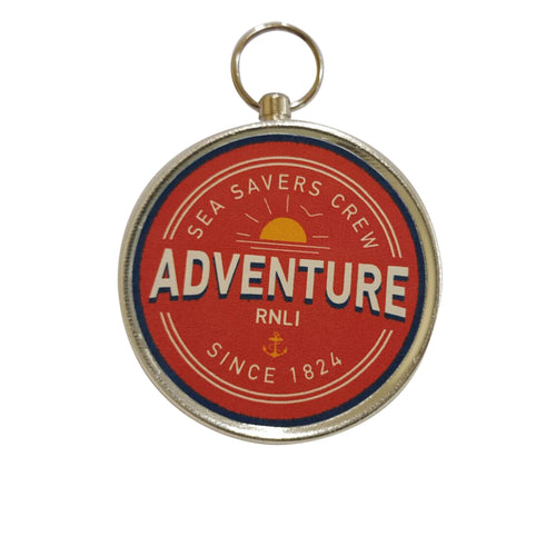 RNLI Junior metal compass with a red label that says Sea savers Crew. Adventure. RNLI Since 1824.