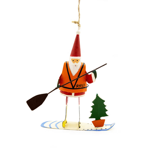 a tin figure of Santa wearing a lifejacket, holding a paddle and standing on a board. 