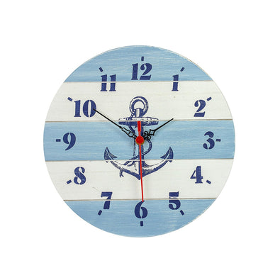 A circular clock in blue and white slatted wood with a navy anchor illustration in the centre.